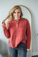 Model standing facing forward wearing henley sweater