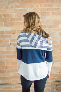Model showing back view of striped hoodie navy liner