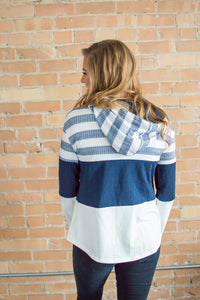 Model showing back view of striped hoodie.